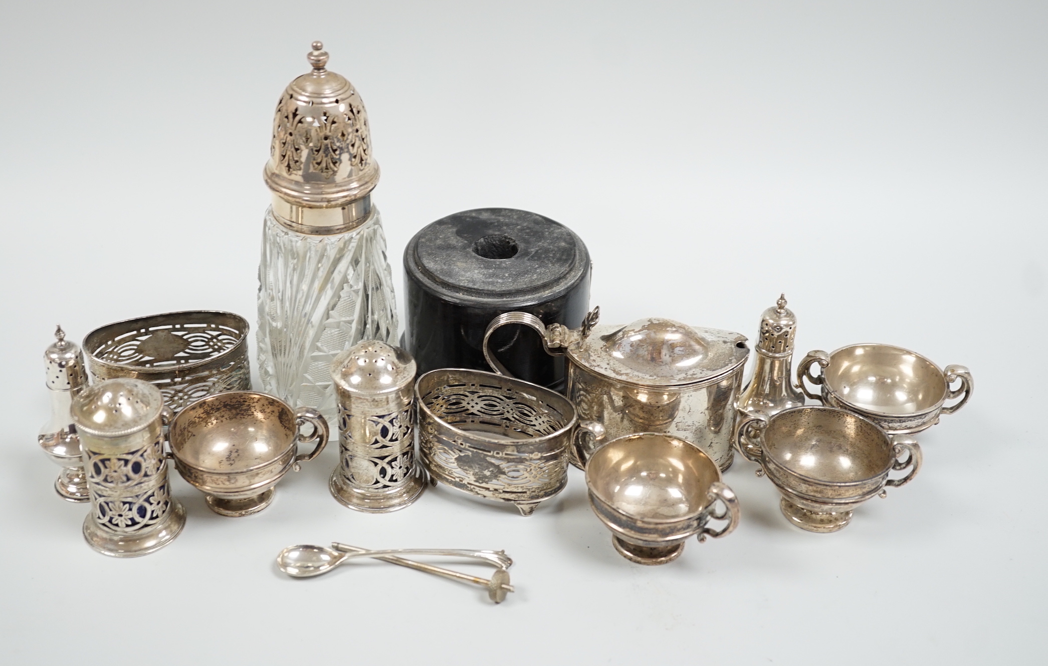 Sundry silver items including mainly condiments and a silver mounted glass caster.